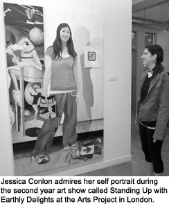 Jessica Conlon admires her self portrait during the second year art show called Standing Up with Earthly Delights at the Arts Project in London. Conlon took home first prize.